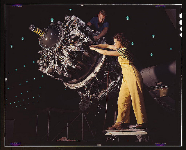woman works on aircraft motor